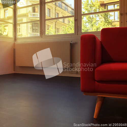 Image of Red armchair in empty room