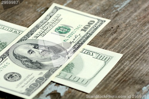 Image of Close-up of a 100 dollars banknotes on wooden background