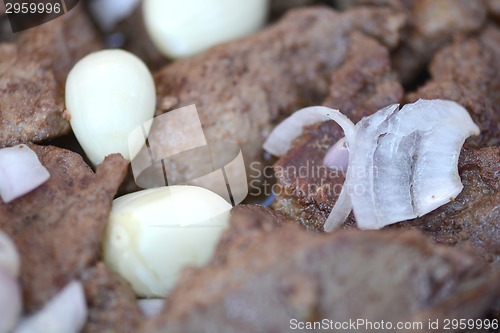 Image of macro food, garlic on fried liver