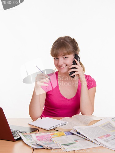 Image of Girl talking on the phone to a newspaper ad