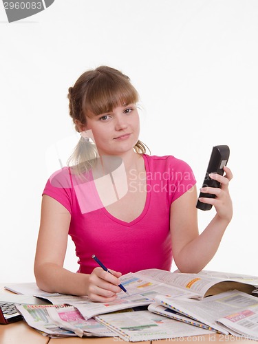 Image of Girl calls an ad in gazate