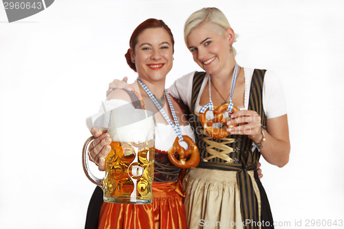 Image of Two bavarian girls with beer in traditional costumes