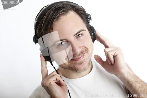 Image of Attractive man with headphones in front of a white background lo