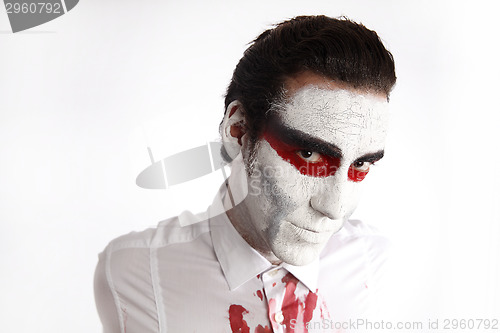 Image of Man with white mascara and bloody shirt