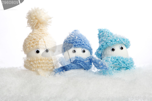 Image of Eggs with hats in the snow