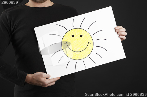Image of Man holding billboard with sun