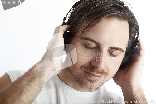 Image of Attractive man with headphones in front of a white background en