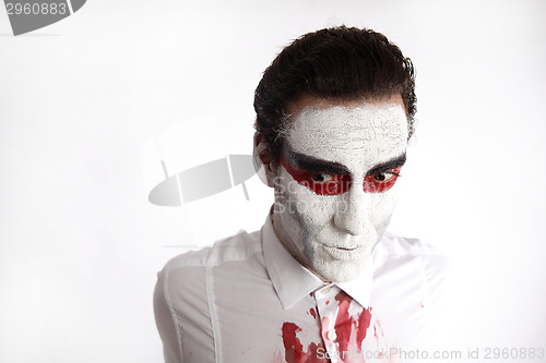 Image of Man with white mascara and bloody shirt 