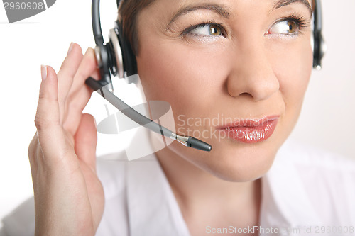 Image of Young woman with headset has problems to understand the caller