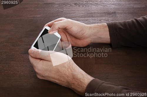 Image of Man using mobile smart phone