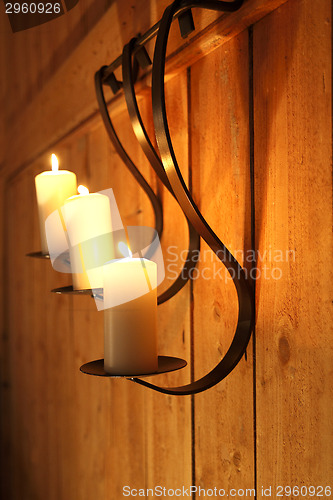 Image of Burning candles as wall decoration
