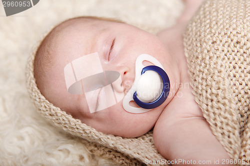 Image of Sleeping baby lying on a blanket