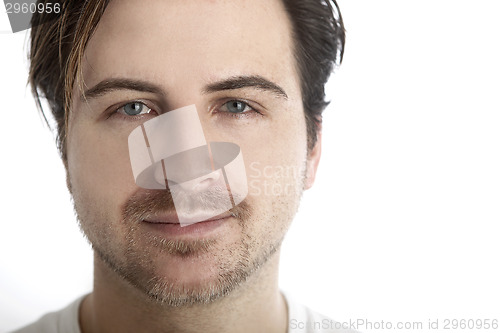 Image of Attractive man in front of a white background looks straight int