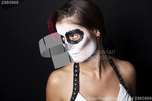 Image of Woman with makeup of la Santa Muerte with red rose