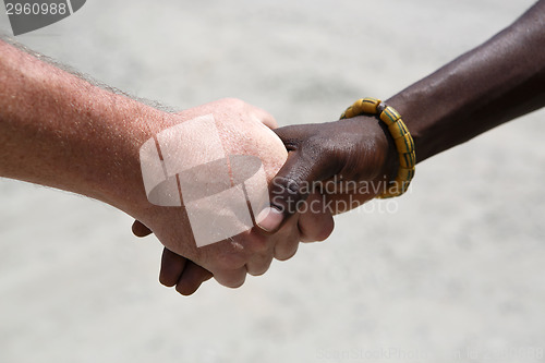 Image of Handshake between a Caucasian and an African