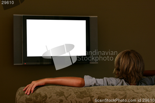Image of boy sitting on couch watching widescreen television