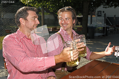 Image of Two Bavarians sitting in a beer garden 