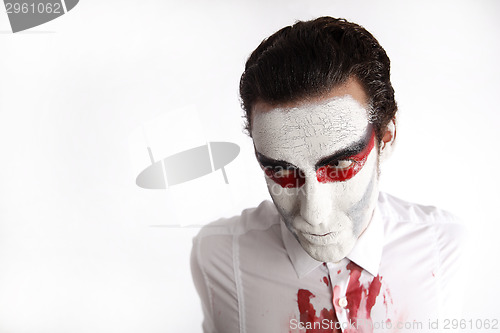Image of Man with white mascara and bloody shirt