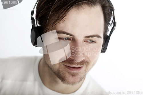 Image of Attractive man with headphones in front of a white background en