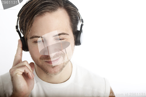 Image of Attractive man with headphones in front of a white background en