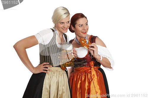 Image of Two bavarian girls with beer in traditional costumes