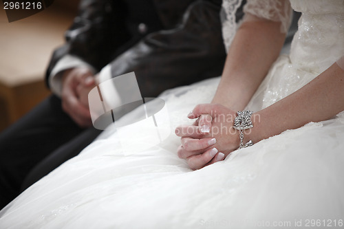 Image of Hands of a bride and groom