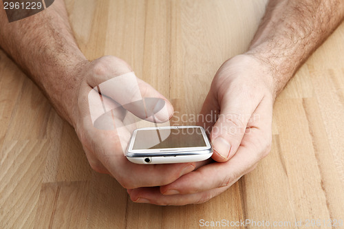 Image of Man using mobile smart phone