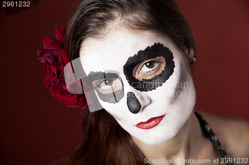 Image of Woman with makeup of la Santa Muerte with red roses