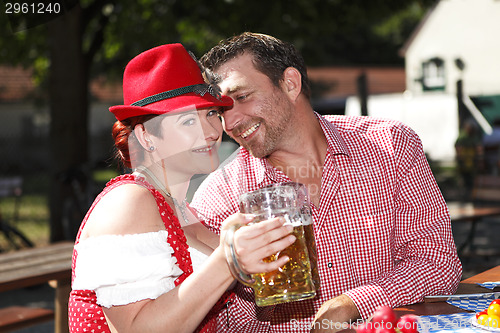 Image of Couple in traditional costumes in a Bavarian beer garden