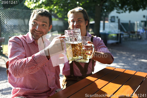 Image of Two Bavarians sitting in a beer garden 