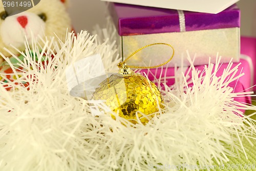 Image of Christmas red gift with yellow balls, new year card