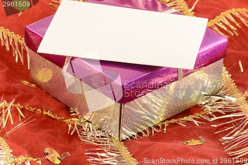 Image of A red gift with a white ribbon and a bow