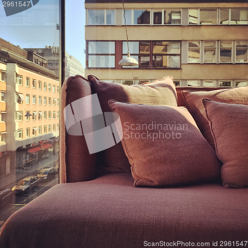 Image of Purple sofa in a room with city view