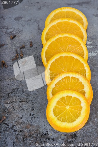 Image of Orange slices arranged on a dark background