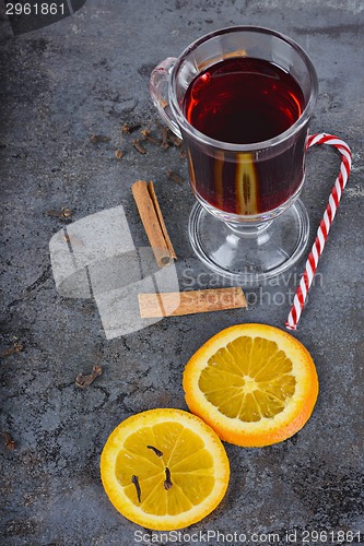 Image of Red mulled wine, spices and candy cane