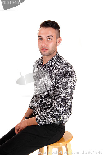 Image of Young man sitting on chair.