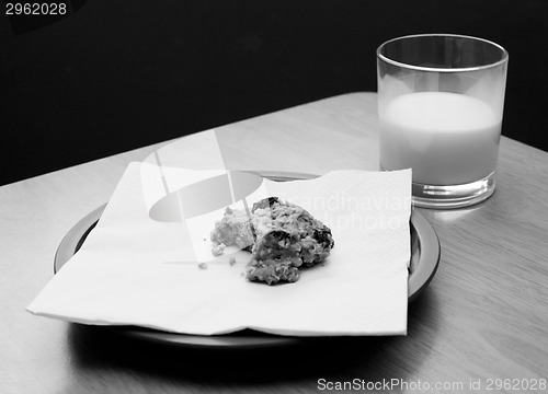 Image of Half-eaten cookie with a half drunk glass of milk