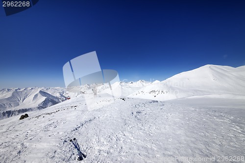 Image of Ski poles on snow slope at nice day