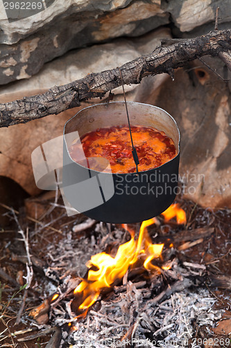 Image of Borscht (Ukrainian soup) cooking on campfire