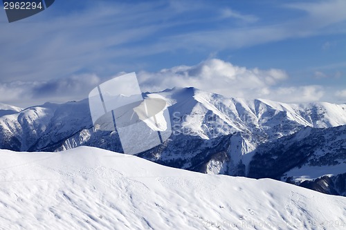 Image of Off-piste slope and sky with clouds at evening