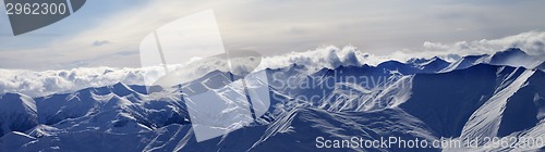 Image of Panorama of evening mountains in clouds