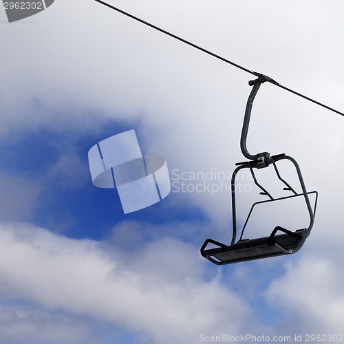 Image of Chair-lift and cloudy sky