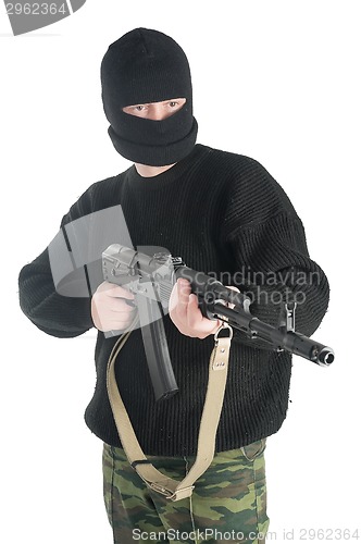 Image of Man in black mask stands with AK-74 machine gun