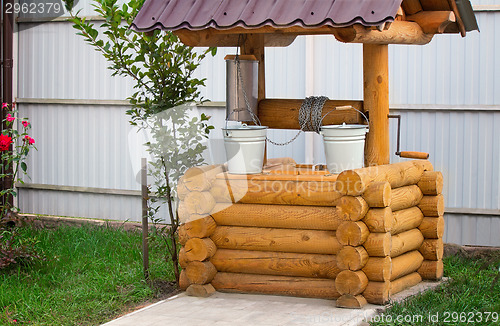 Image of Wooden well with buckets for water.