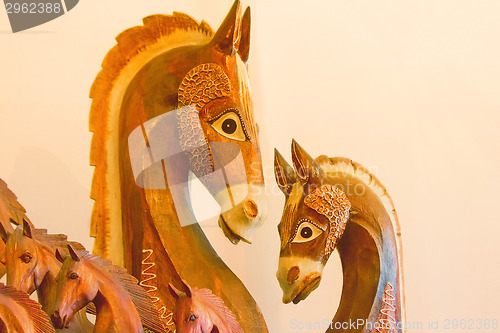 Image of The figures of horses made of a tree.