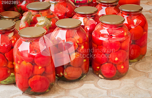 Image of  Tinned tomatoes in big glass jars.