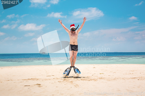 Image of Man in santa hat on the tropical beach