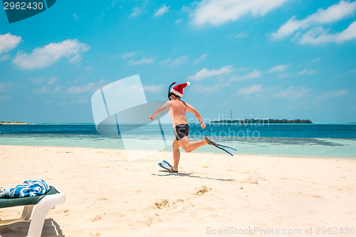 Image of Man in santa hat on the tropical beach