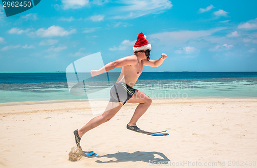 Image of Man in santa hat on the tropical beach