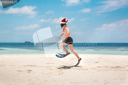 Image of Man in santa hat on the tropical beach